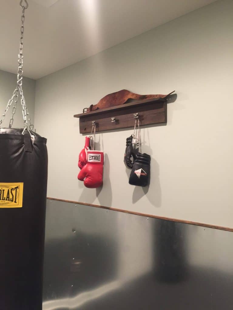 home gym boxing gloves hung on wall shelf. 
