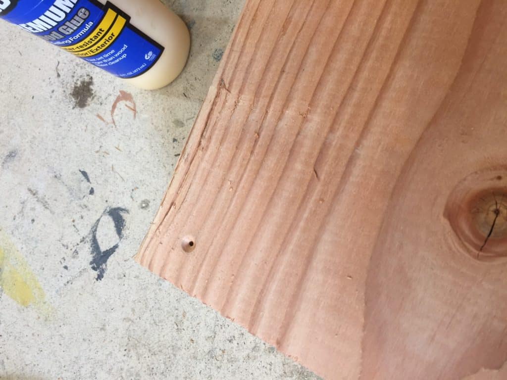 Scottie countersinks holes in 2x12 support pieces of wood for the headboard