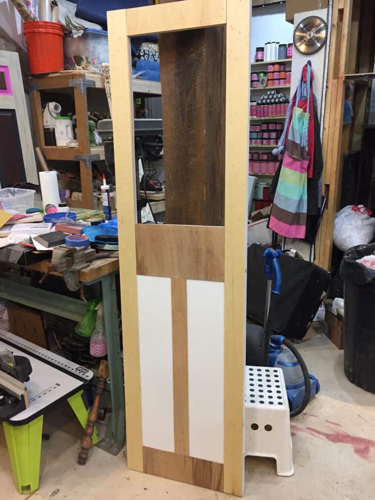 finished door trim added to hollow core door for makeover in workshop environment