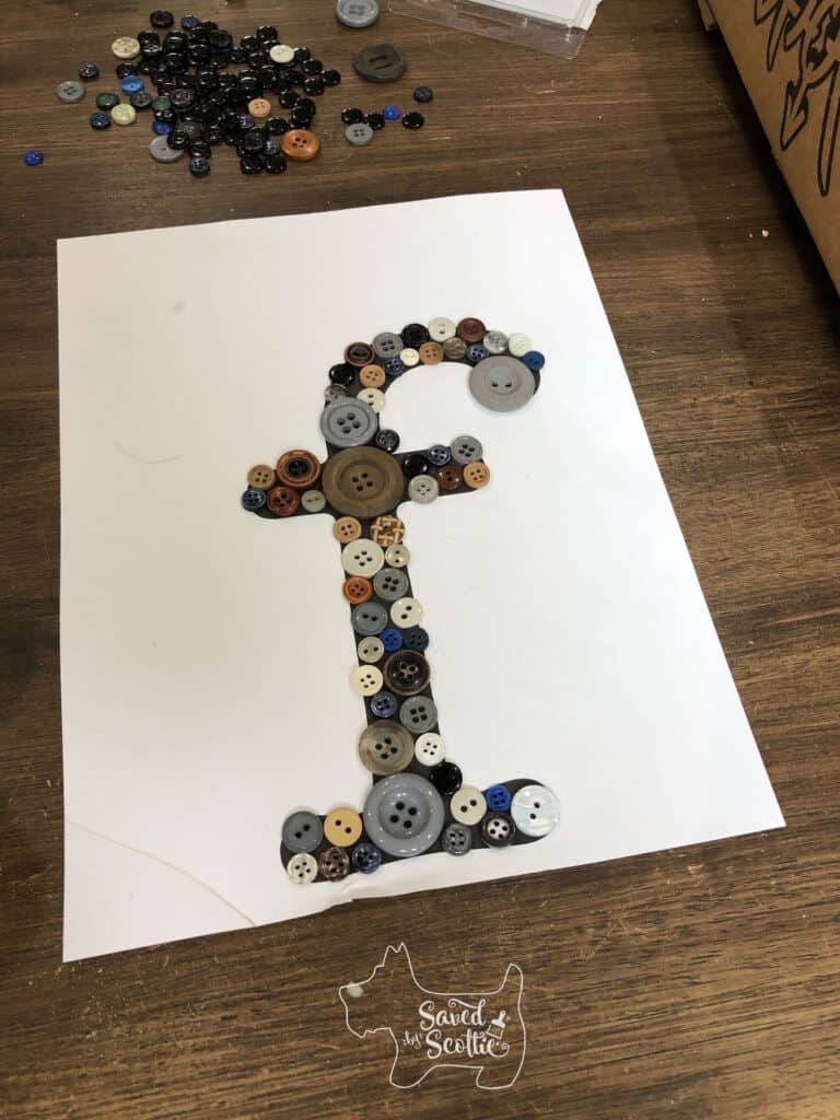 printed lowercase letter f with buttons spread out across it. 