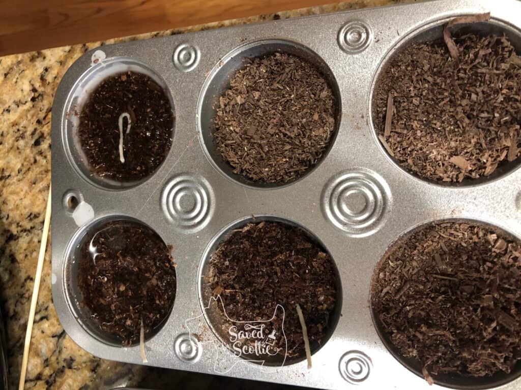 muffin tin with no paper liners. some tins are filled with liquid wax and wicks and others are only wood shavings 