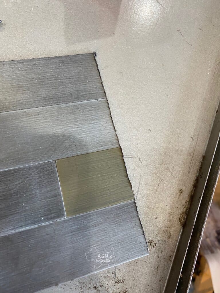 cut reclaimed metal tile from Aspect Tile with rough edge 