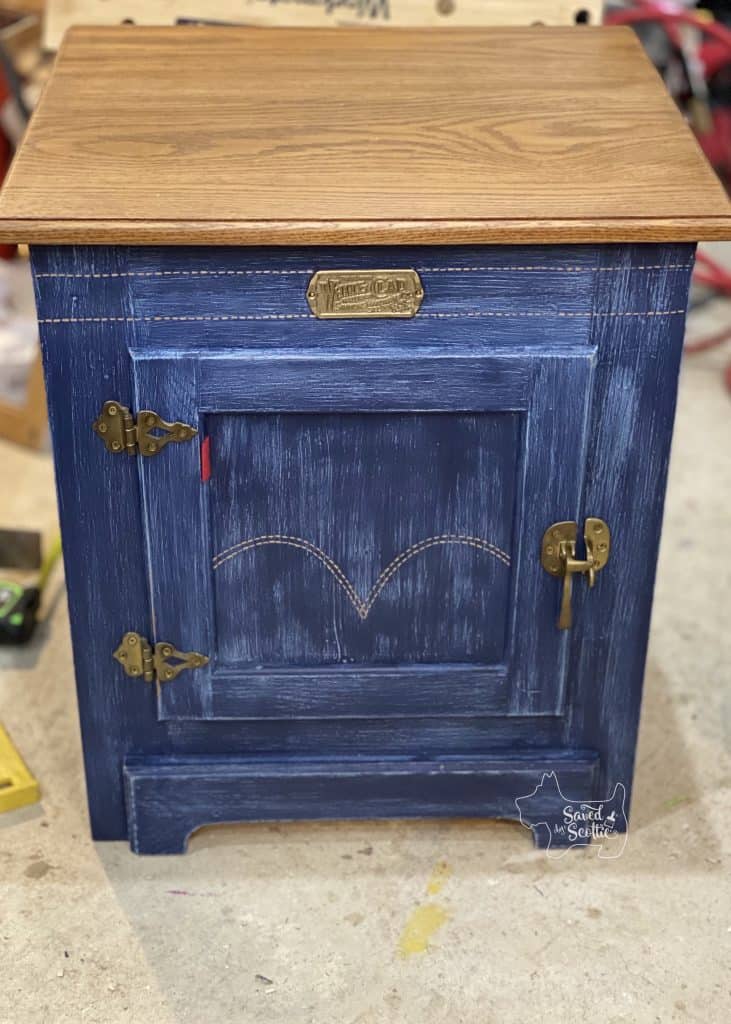 finished white clad furniture side table. Inspired by denim jeans. two tone with iconic levis tag and pocket pattern painted on door. brass hardware