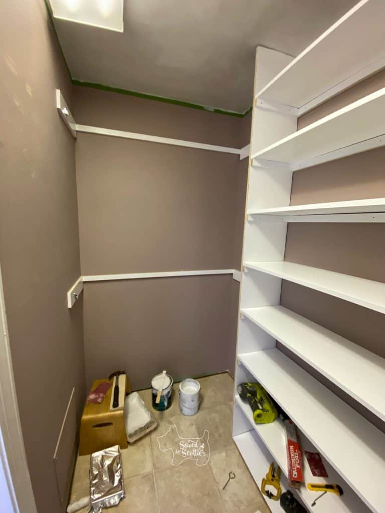 closet makeover with trim on wide shelving unit and double hangers in place