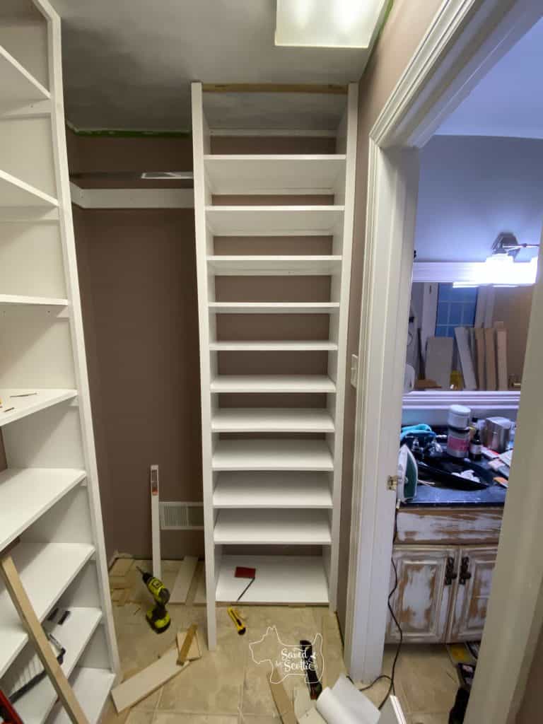 nearly finished shoe storage unit of closet makeover needs top trim