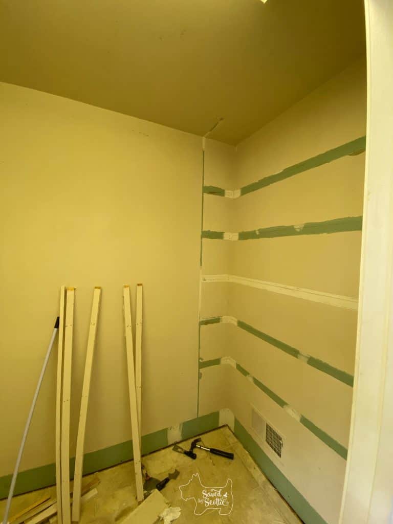 wall after shelving removal with shadowing where shelves used to be. 